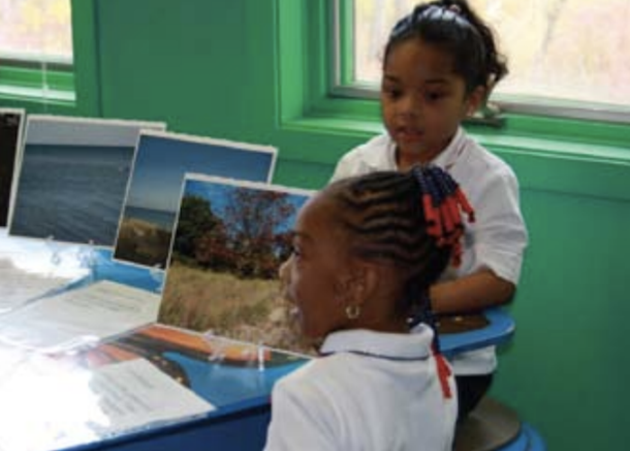 two kindergarteners showing off their nature photographs