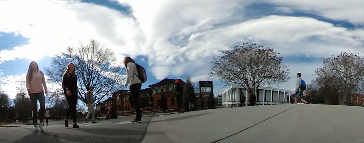 distorted 360 still of students walking across campus